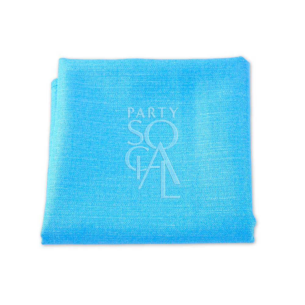 Linen blend napkin folded elegantly, ideal for events. Premium quality in blue. Versatile sizes: Cocktail (25cm L x 25cm W), Dinner (50cm L x 50cm W). From 48 AED. Napkins from Party Social Dubai.
