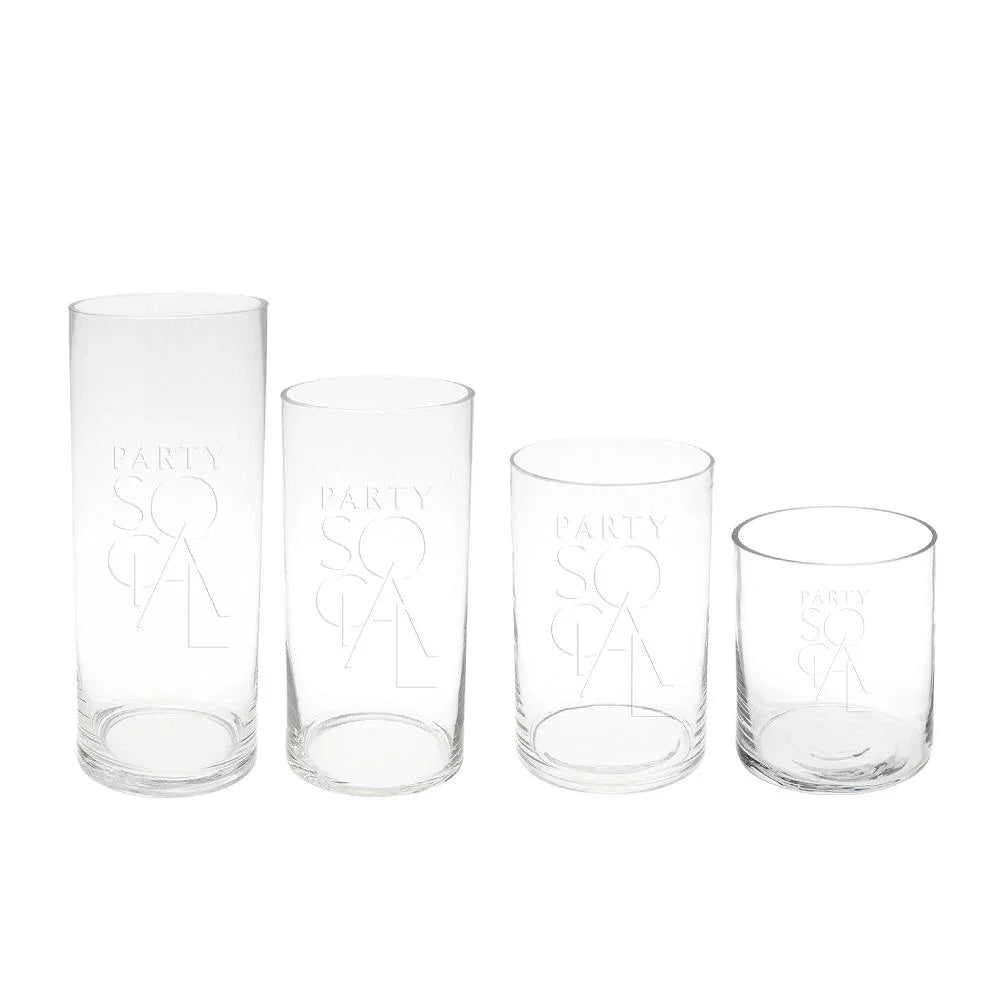 A group of cylinder glass vases, perfect for brightening tables or consoles with flowers or candles. Available in various sizes: Extra Small, Small, Medium, and Large. From Party Social. Tableware from Party Social Dubai.