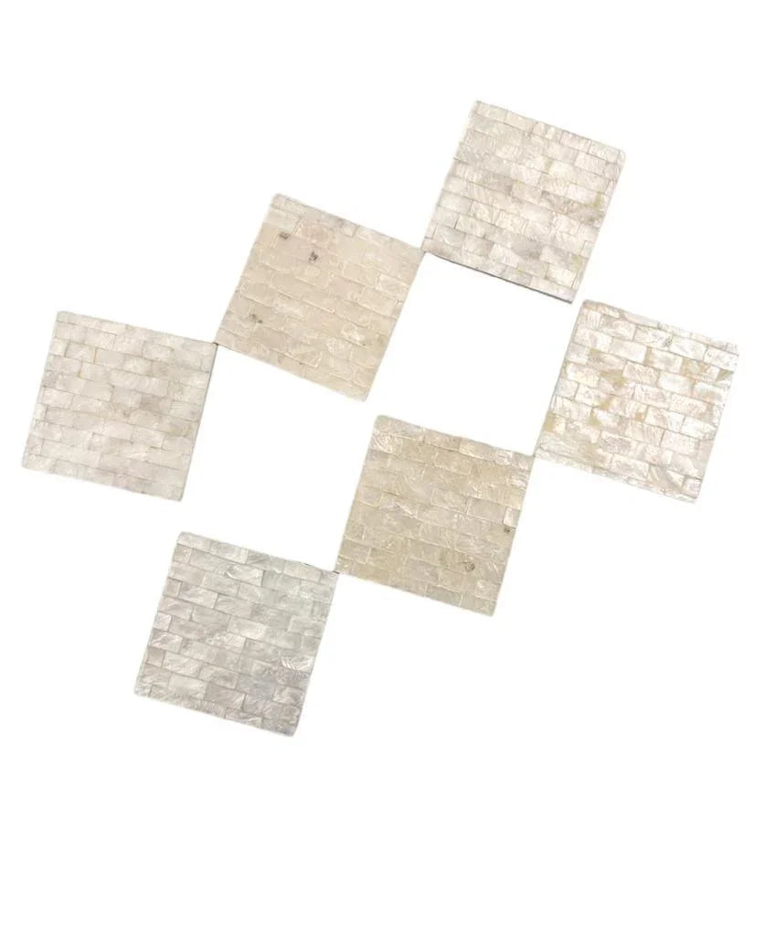 A set of premium white square tiles, featuring a close-up of a white brick. Perfect for adding a touch of elegance to your home and events. Coaster Seashells.