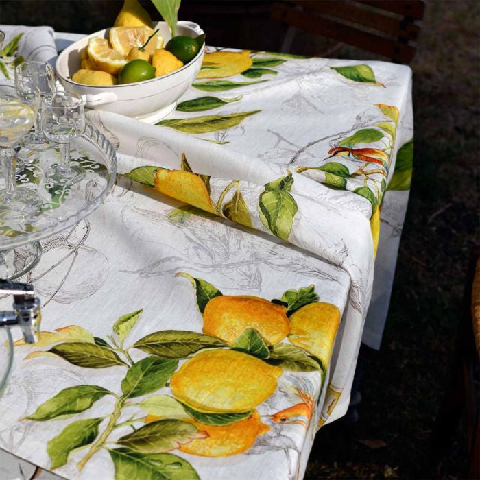 Limoncello Pure Linen Tablecloth with lemons and limes on a table.