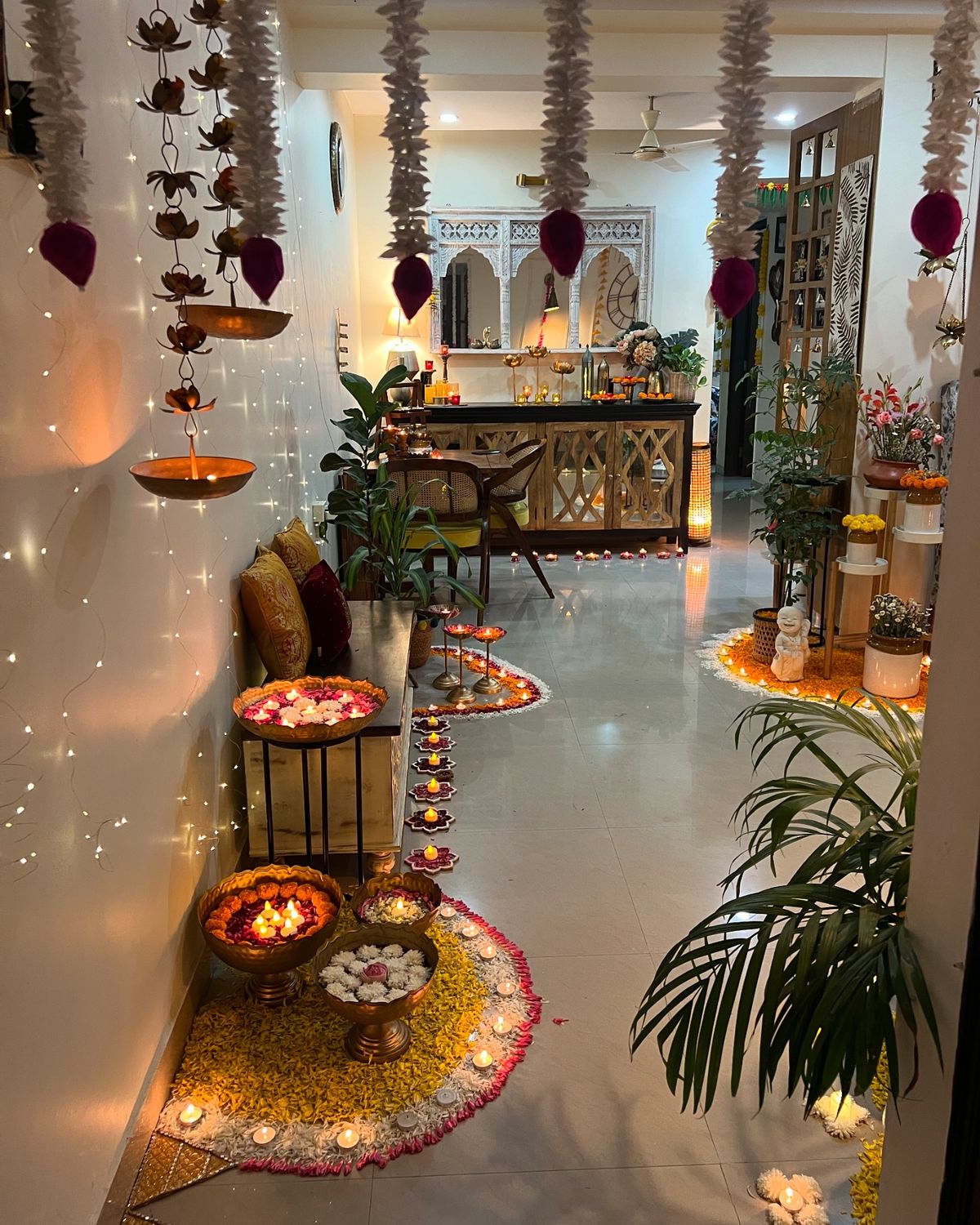 Elegant Diwali party table setup featuring golden dinnerware, rich red and gold linens, decorative candles, and festive floral accents creating a luxurious ambiance.