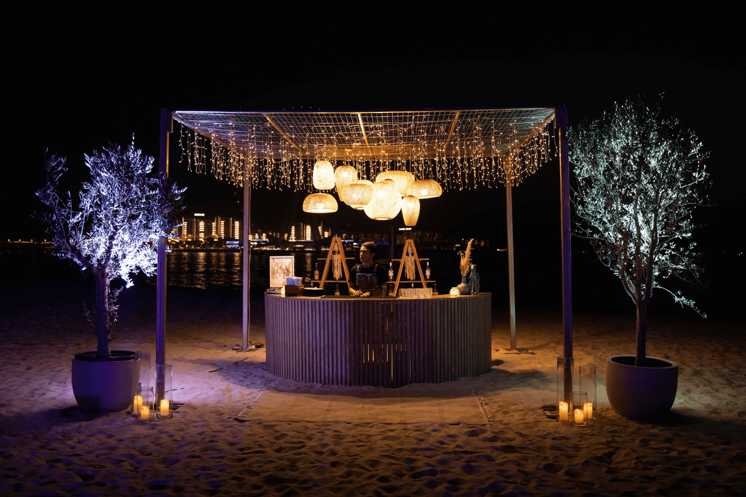 Beach chairs and umbrellas under the night sky, provided by Party Social Event Rentals Dubai.