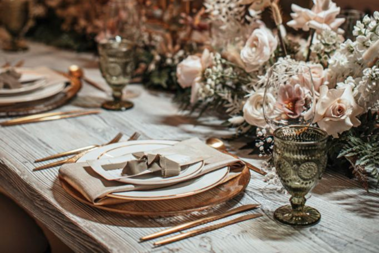Elegant table setting adorned with gold and white flowers, showcasing sophistication by Party Social Event Rentals Dubai.