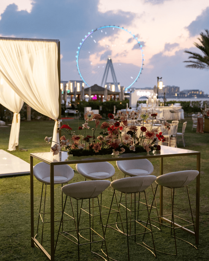 A picturesque wedding venue featuring a ferris wheel in the background, elegantly arranged by Party Social Event Rentals Dubai.