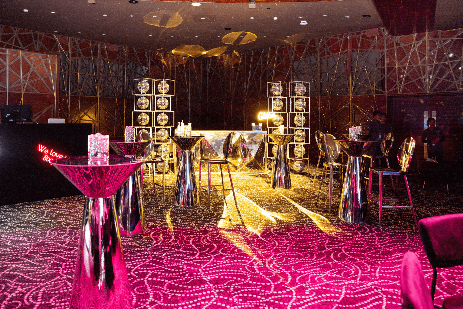 A room featuring a bar area with high tables and stools, perfect for gatherings and casual dining.