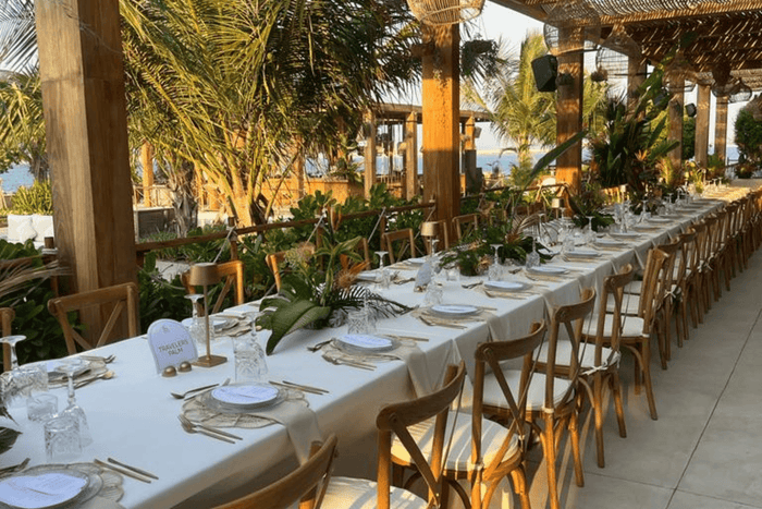 A beautifully arranged long table for a boho-themed wedding reception, elegantly set by Party Social Event Rentals Dubai.