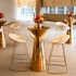 Golden Glam- Cocktail Setup featuring a table, eight stools, and a flower centerpiece, ideal for an elegant event gathering.