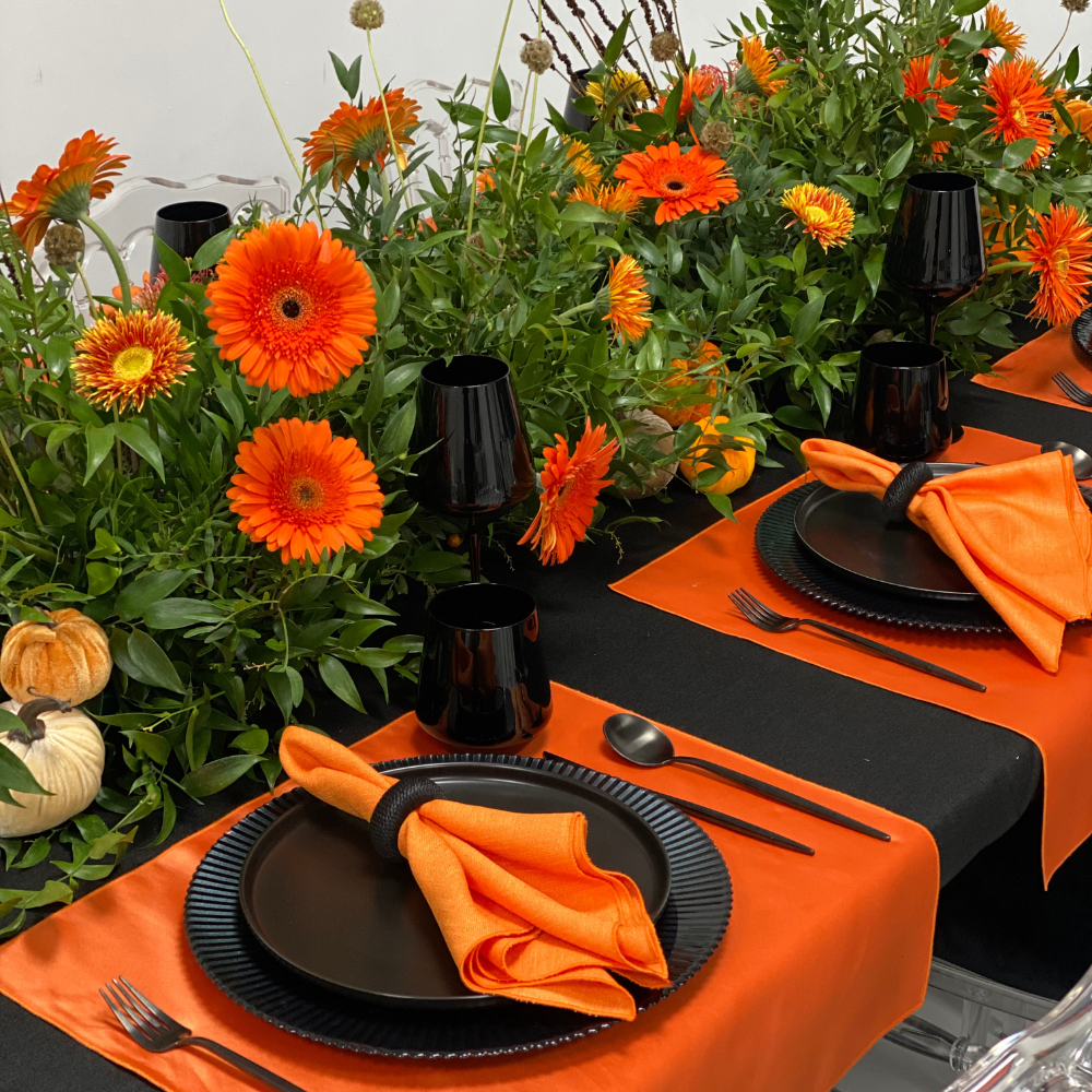 Pumpkins & Petals- Dining Setup: Elegant autumn tablescape for 8, featuring black and orange elements with lush floral centerpiece, perfect for fall gatherings.