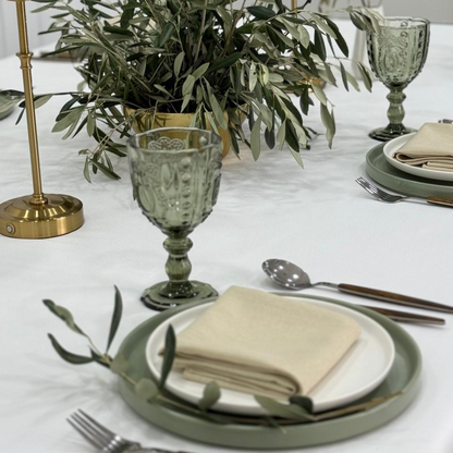 Serene Green- Dining Setup: Elegant table with dinnerware for eight, featuring plates, wooden cutlery, goblets, napkins, and a flower centerpiece. Ideal for special occasions.