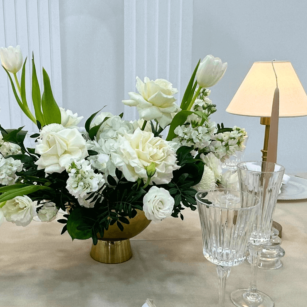 Sand Elegance- Dining Setup featuring a flower centrepiece, wine glasses, and tableware for eight guests, showcasing elegant event essentials from Party Social.