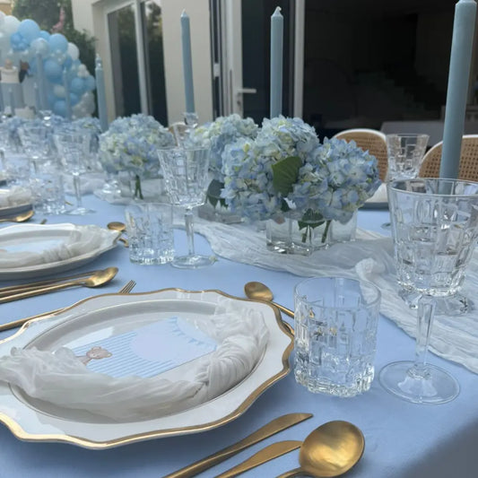 White Lotus Collection chargers elegantly displayed with gold-tone flatware and crystal glassware, creating a sophisticated dining setup perfect for upscale events or gatherings.