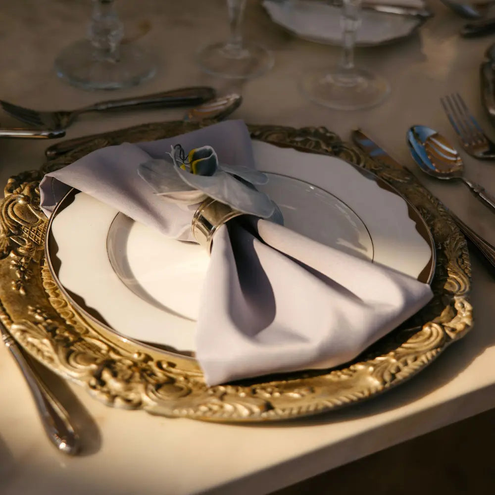 CHARGER PLATE - FLORENTINE ANTIQUE WOOD at an elegant dinner setting with silverware, showcasing its handcrafted Italian design ideal for luxurious events.