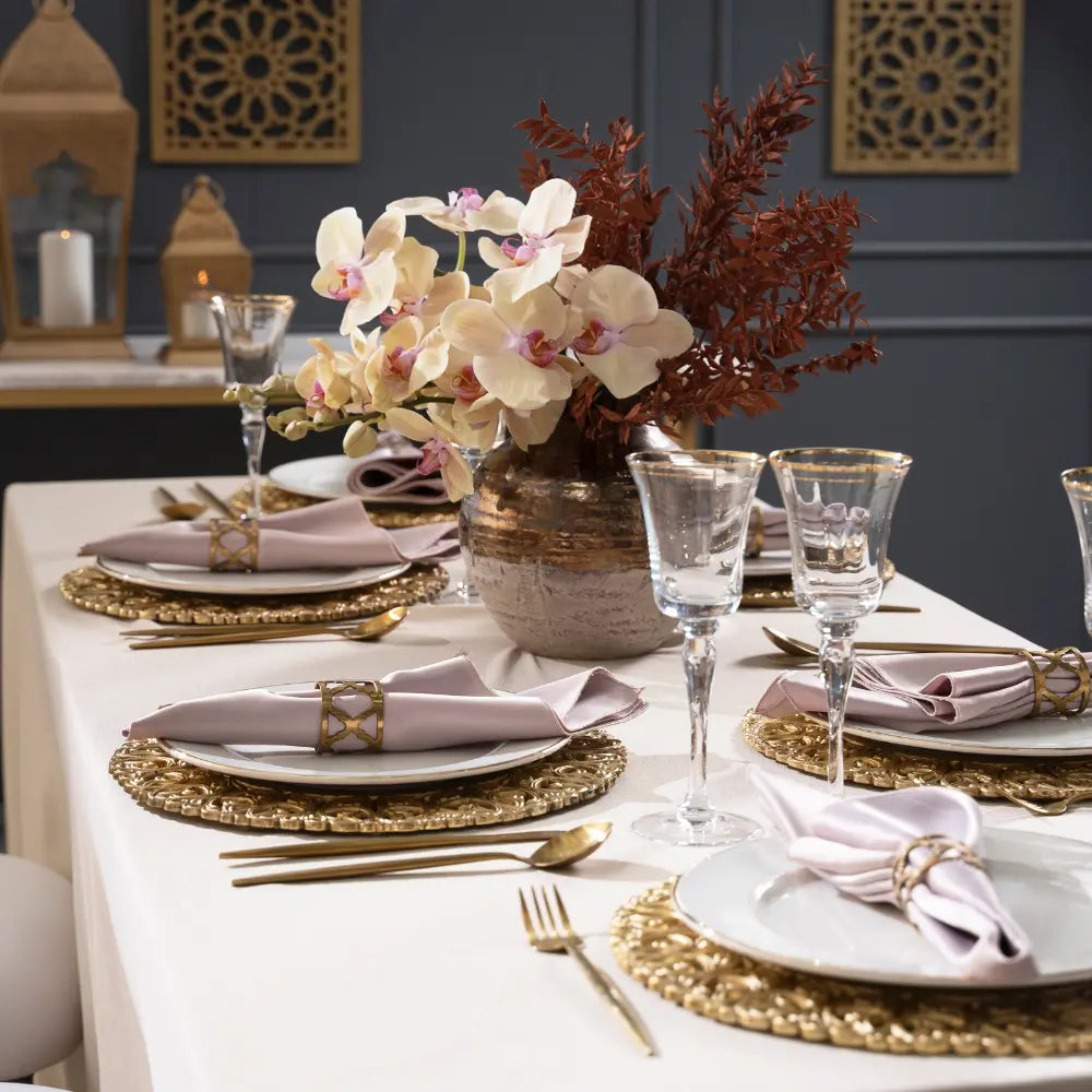 CHARGER PLATE - BRASS elegantly set on a formal dining table with gold flatware and blush napkins, perfect for special occasions or upscale events.