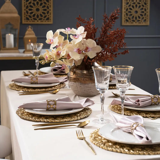 CHARGER PLATE - BRASS elegantly set on a formal dining table with gold flatware and blush napkins, perfect for special occasions or upscale events.