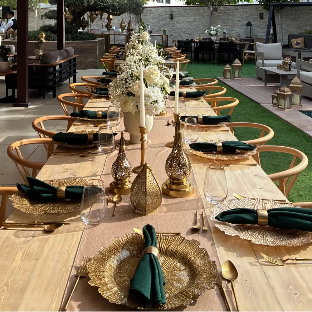 CHARGER PLATE - GOLD STARBURST, set on a formal banquet table with gold-tone accents, enhancing the elegant dining arrangement for a sophisticated event.