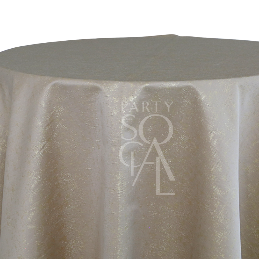 Round table with GOLD SHIMMERING IN GREY TABLE CLOTH, featuring light gold, slightly shimmery fabric with PARTY SOCIAL branding, suitable for events and parties.