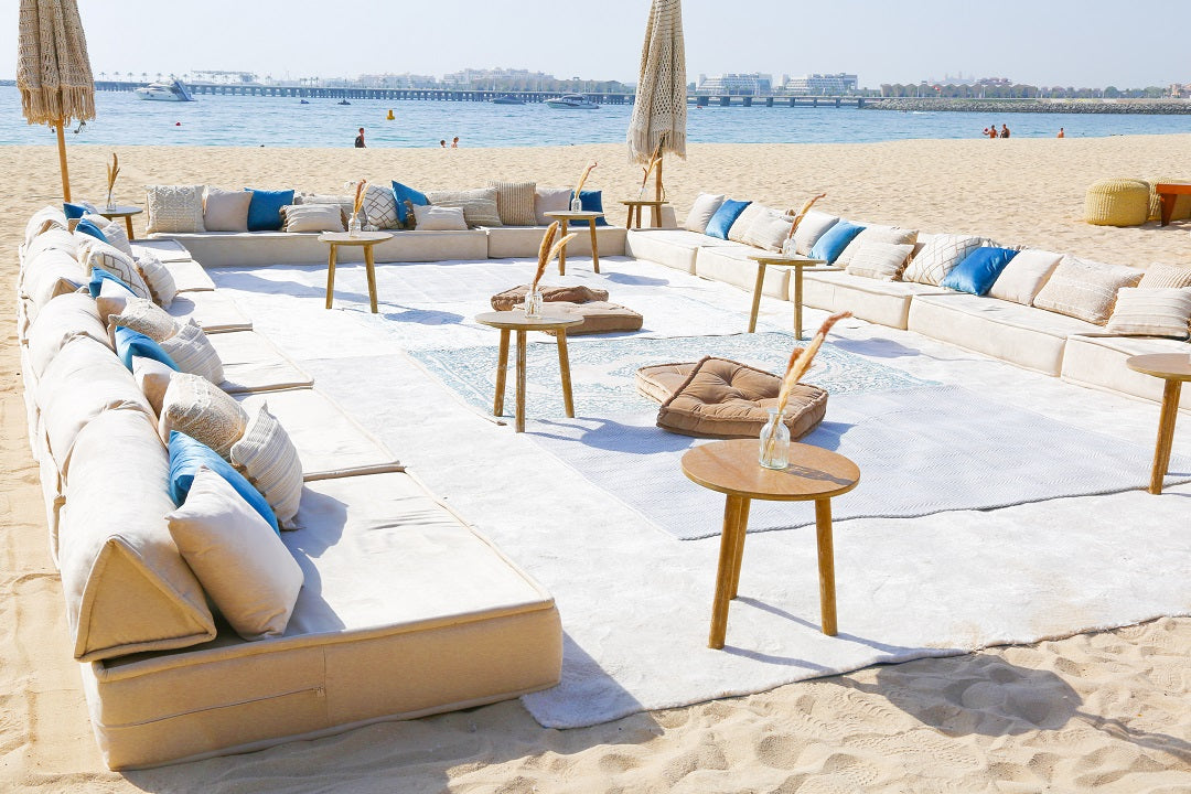 Lounge Low Seating at a beach bar, featuring soft, Arabic-inspired cushions and furniture, ideal for outdoor events by Party Social.