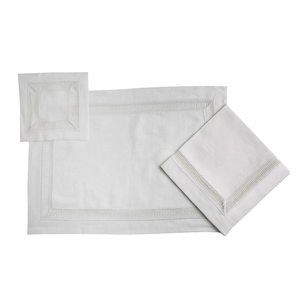 A white linen placemat with a square border and lace trim, perfect for elegant table setups.