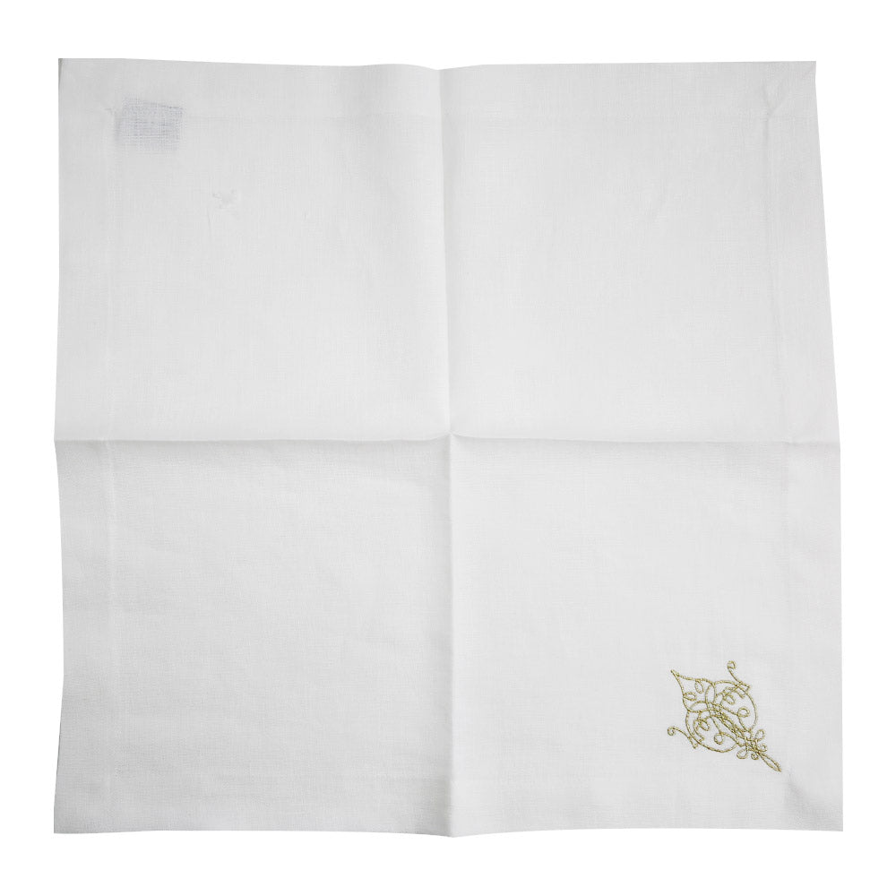 A white linen dinner napkin with a gold design, perfect for elegant table setups.