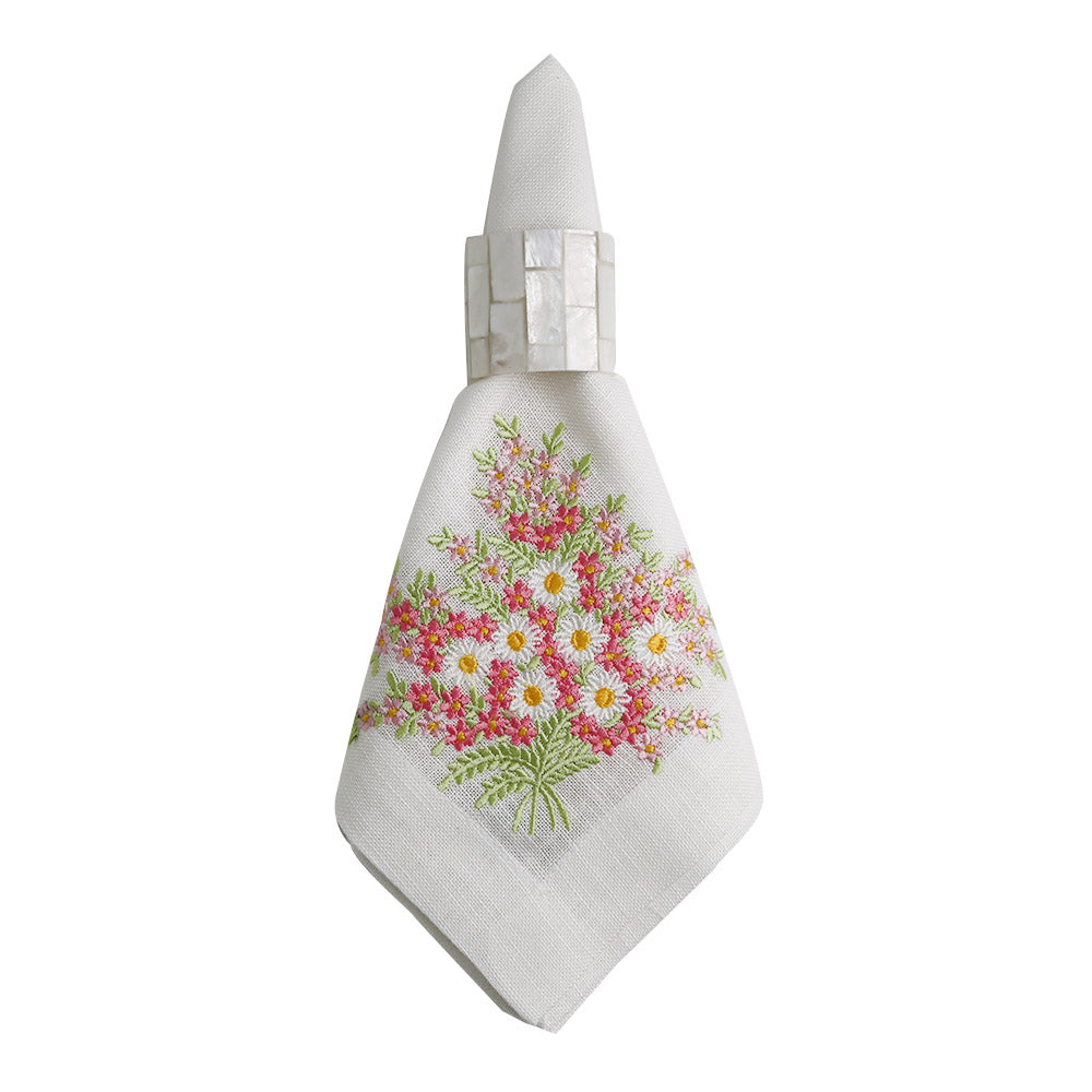 A white linen dinner napkin with a floral design, perfect for elegant table setups.