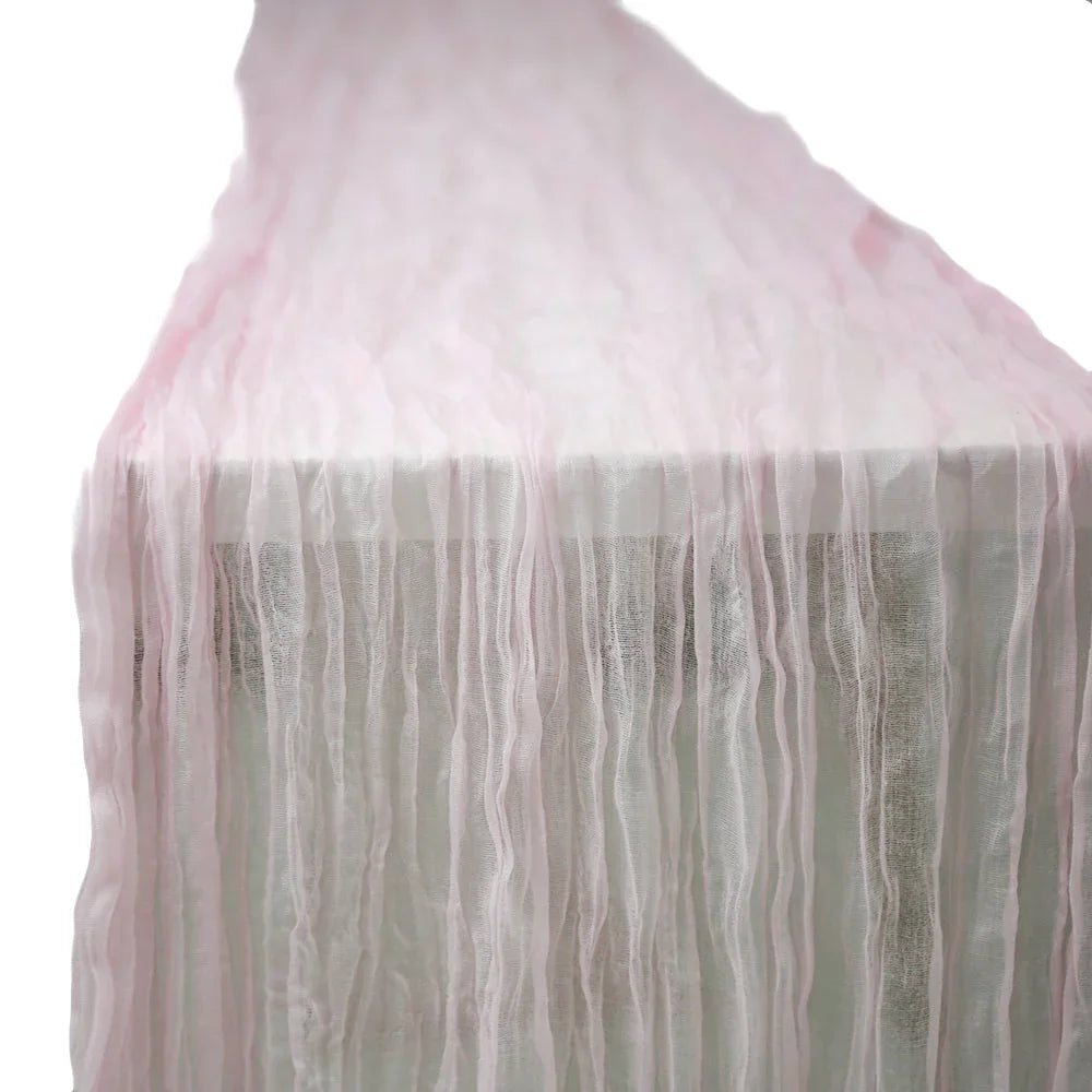 Gauze Table Runners elegantly draped over a long table, showcasing their premium creased effect, ideal for enhancing glamorous tabletops at special occasions.