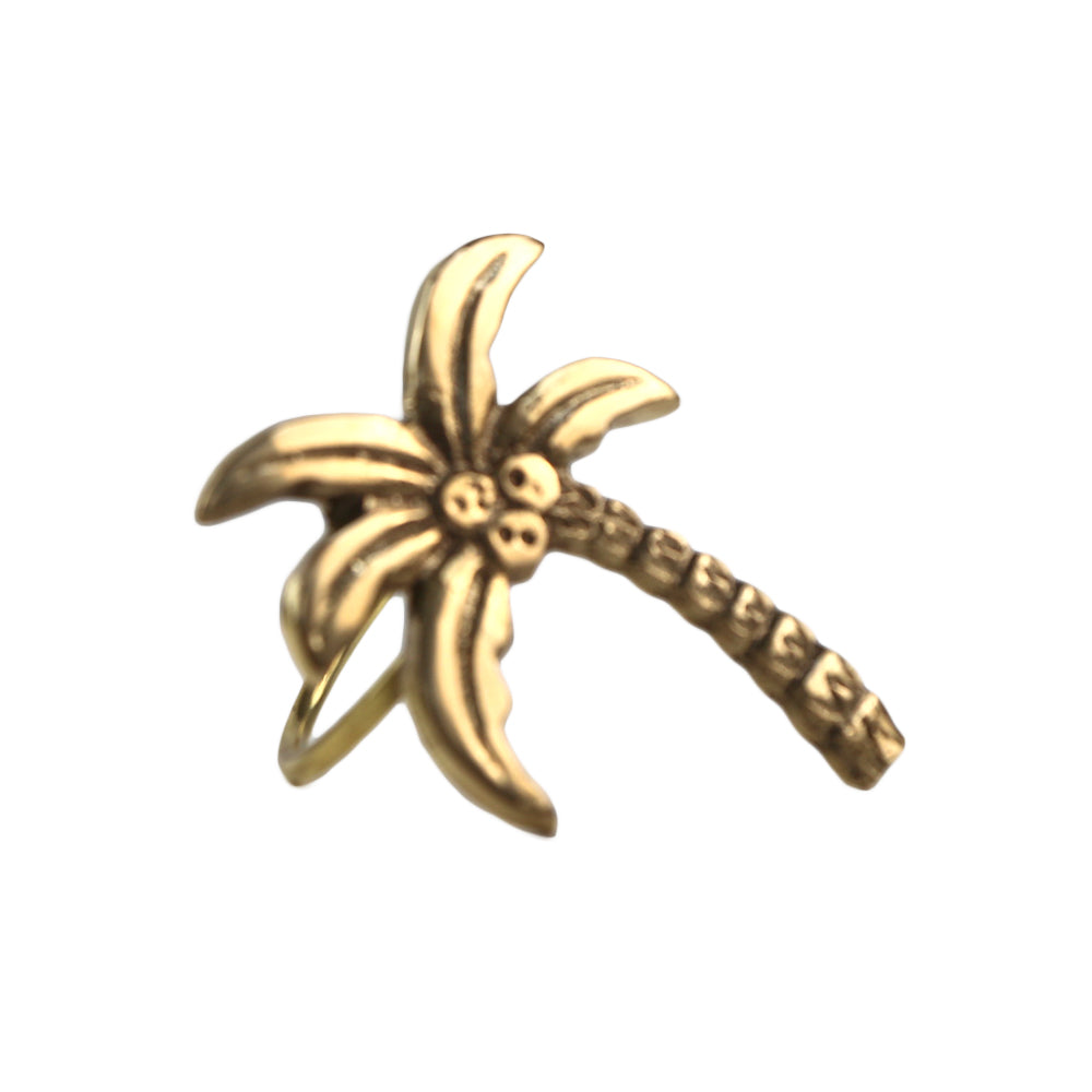 A stylish brass palm tree napkin ring for dining, adding a special touch.
