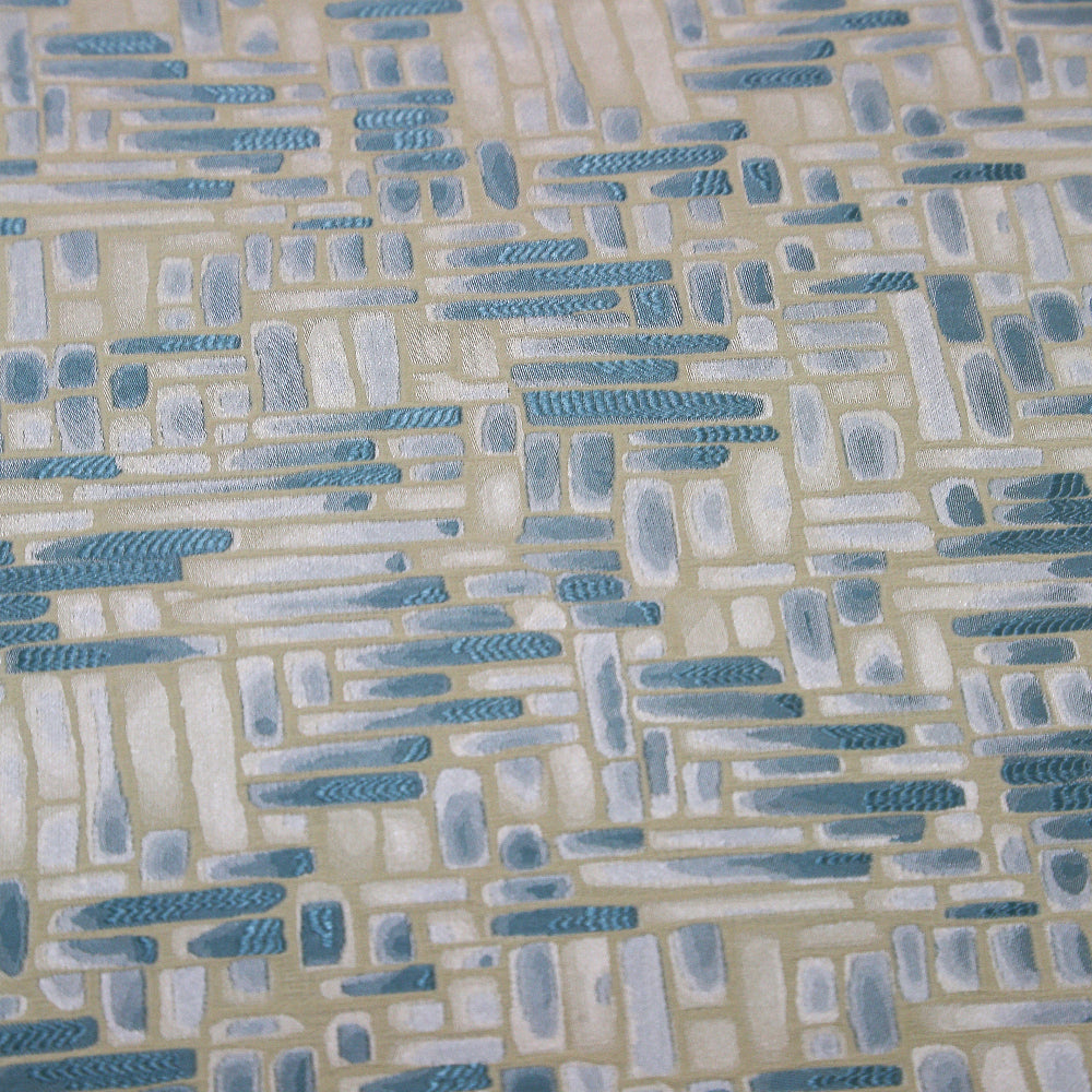 Blue Mosaic Tablecloth features a geometric brush-stroke pattern with teal and off-white shapes on beige, ideal for coastal-themed events and celebrations.