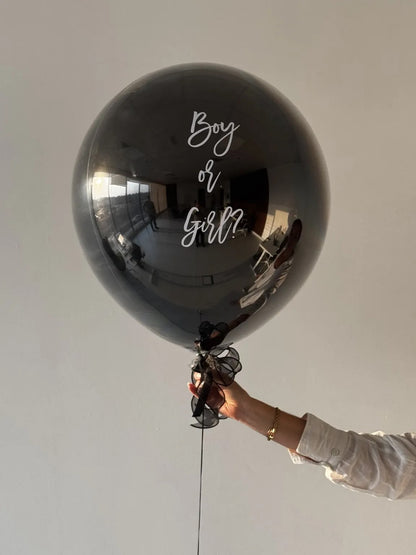 Close-up of the Boy or Girl white script lettering on The Big Reveal Balloon - Party Social Dubai