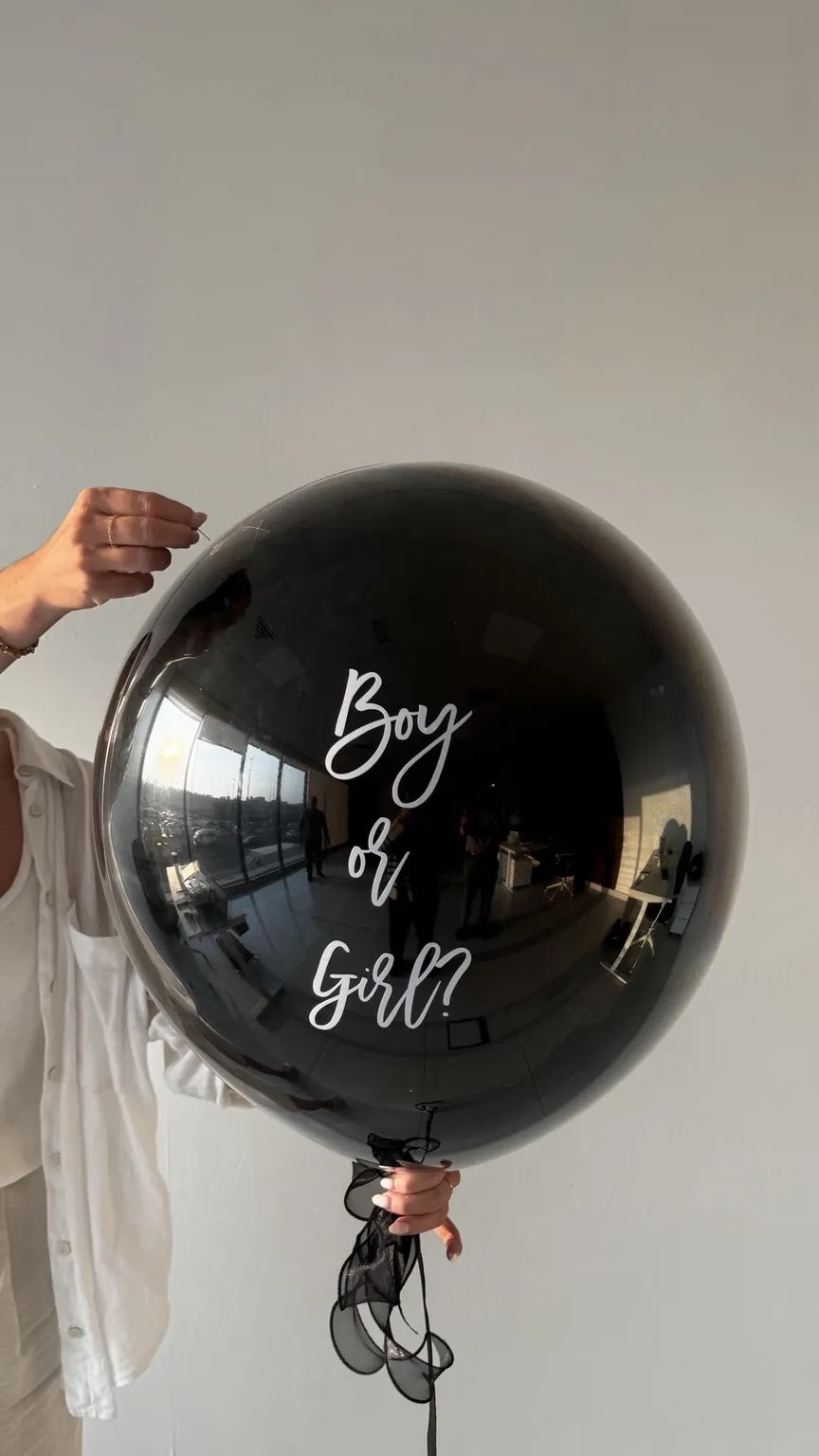The Big Reveal Balloon in black, held ready to pop - no-mess gender reveal balloon Dubai