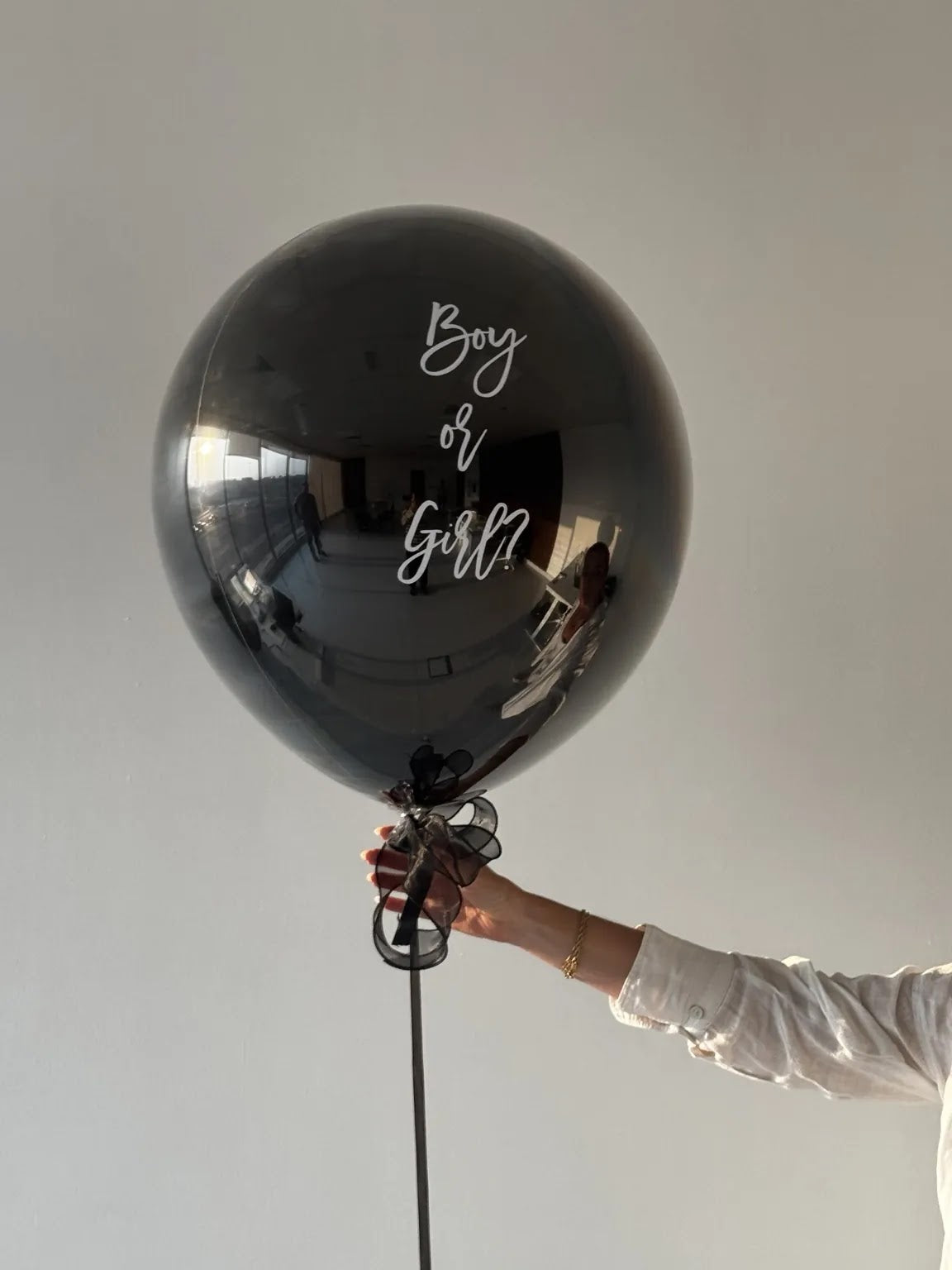The Big Reveal Balloon held by hand before the reveal - gender reveal balloon Dubai