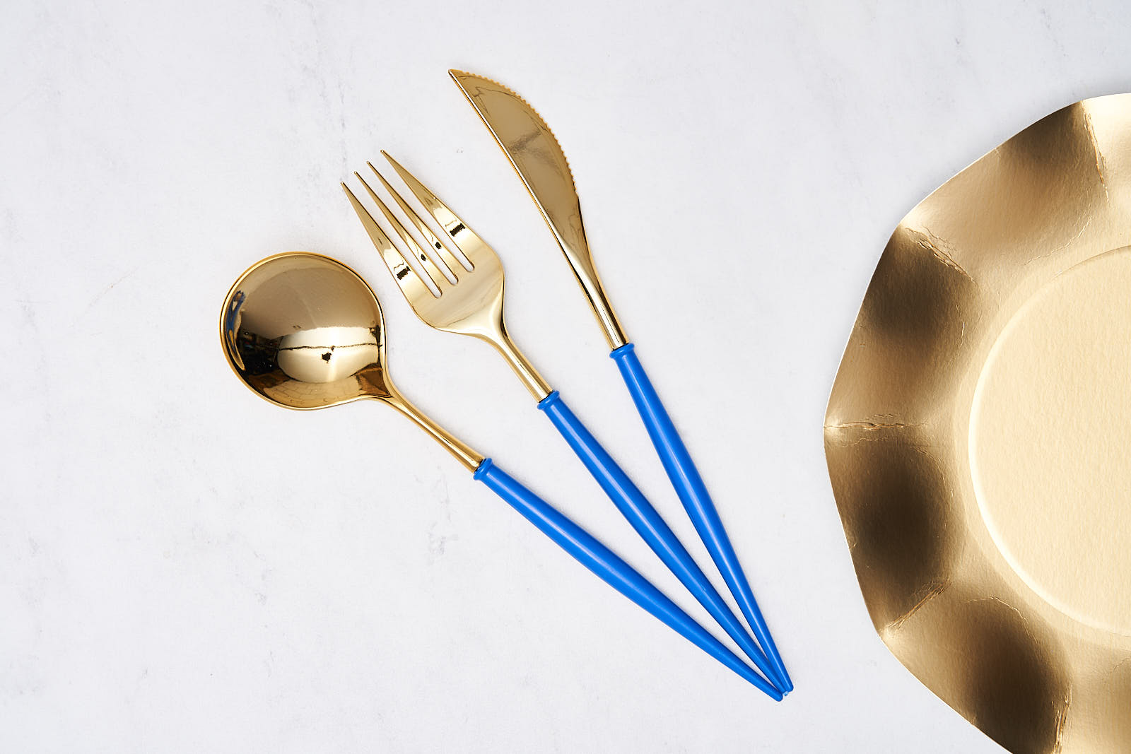 Bella Plastic Cutlery in Gold and Blue featuring a sleek modern design, including a spoon, fork, and knife, ideal for elegant events and table settings.