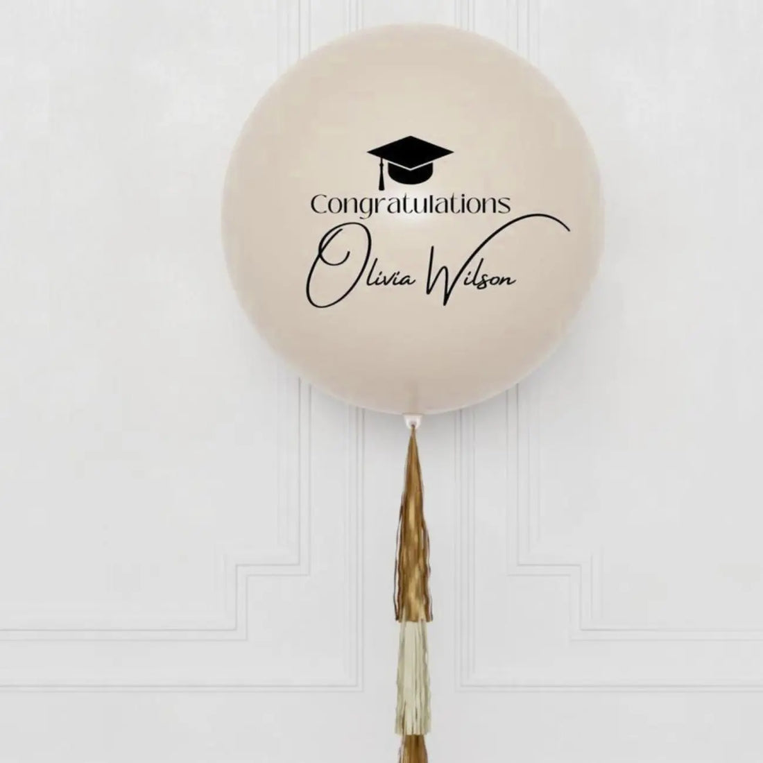 The Luxe Graduate Helium Giant Balloon features a mortarboard icon and Congratulations Olivia Wilson, with a gold and ivory tassel.