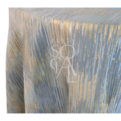CELESTIAL HORIZON TABLECLOTH with textured, iridescent stripes in soft blues and metallic golds, creating a twilight sky effect, ideal for elegant events.
