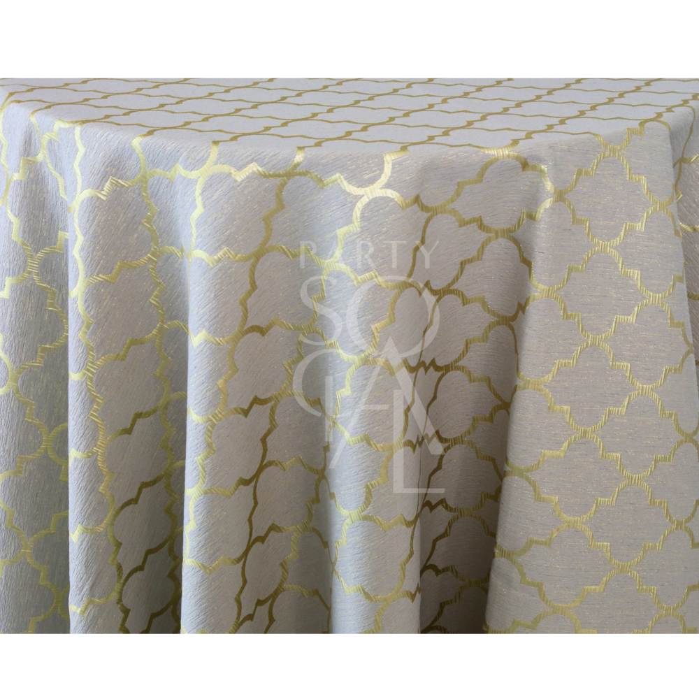 Golden Lattice Tablecloth draped over a round table, featuring a shimmering gold quatrefoil pattern on light-gray fabric, ideal for elegant events.