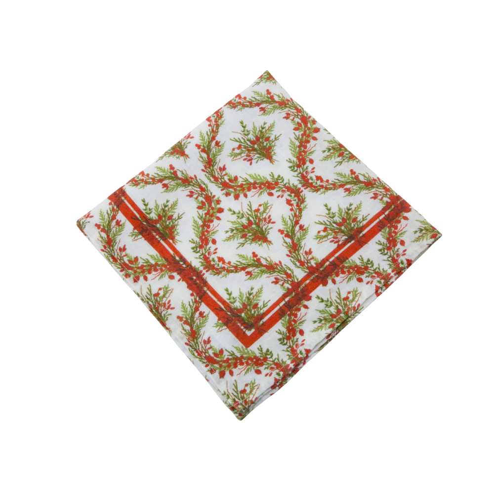 Holly & Pine Linen Napkin- 4 per pack; features festive green foliage and red berries on white, edged in red. Ideal for elevating holiday table settings.