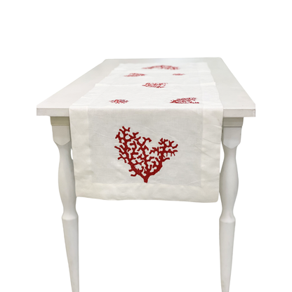 Red Coral Pure Linen Runner displayed on a white wooden table, featuring ivory-white linen with red coral motifs, perfect for elegant party or event setups.