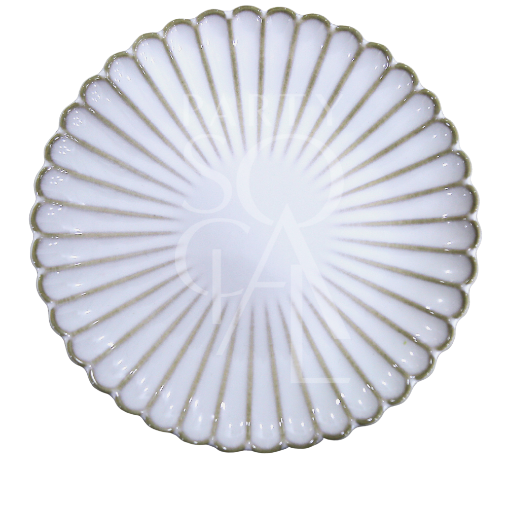 SCALLOPED LIKE PLATES: A round, white ceramic serving plate with scalloped edge and radiating ribbed pattern, perfect for elegant dining presentations from Party Social.