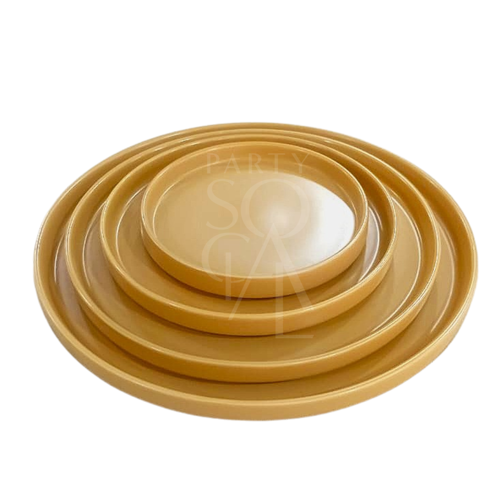 Mustard Ceramic Matte Plates set, featuring four nested, round trays with a smooth matte finish, ideal for sophisticated dining and event setups.