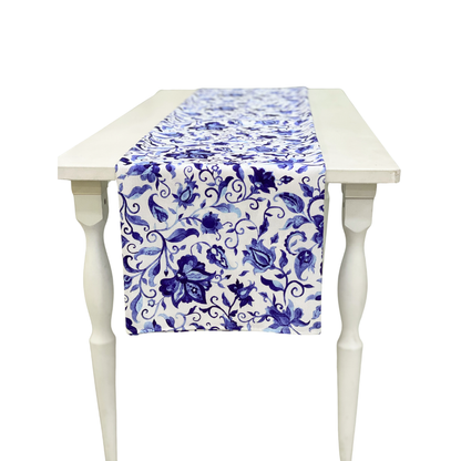 Summer Florals Polyester Linen Runner on a white wooden table, featuring a blue floral pattern, perfect for enhancing special event tablescapes from Party Social.