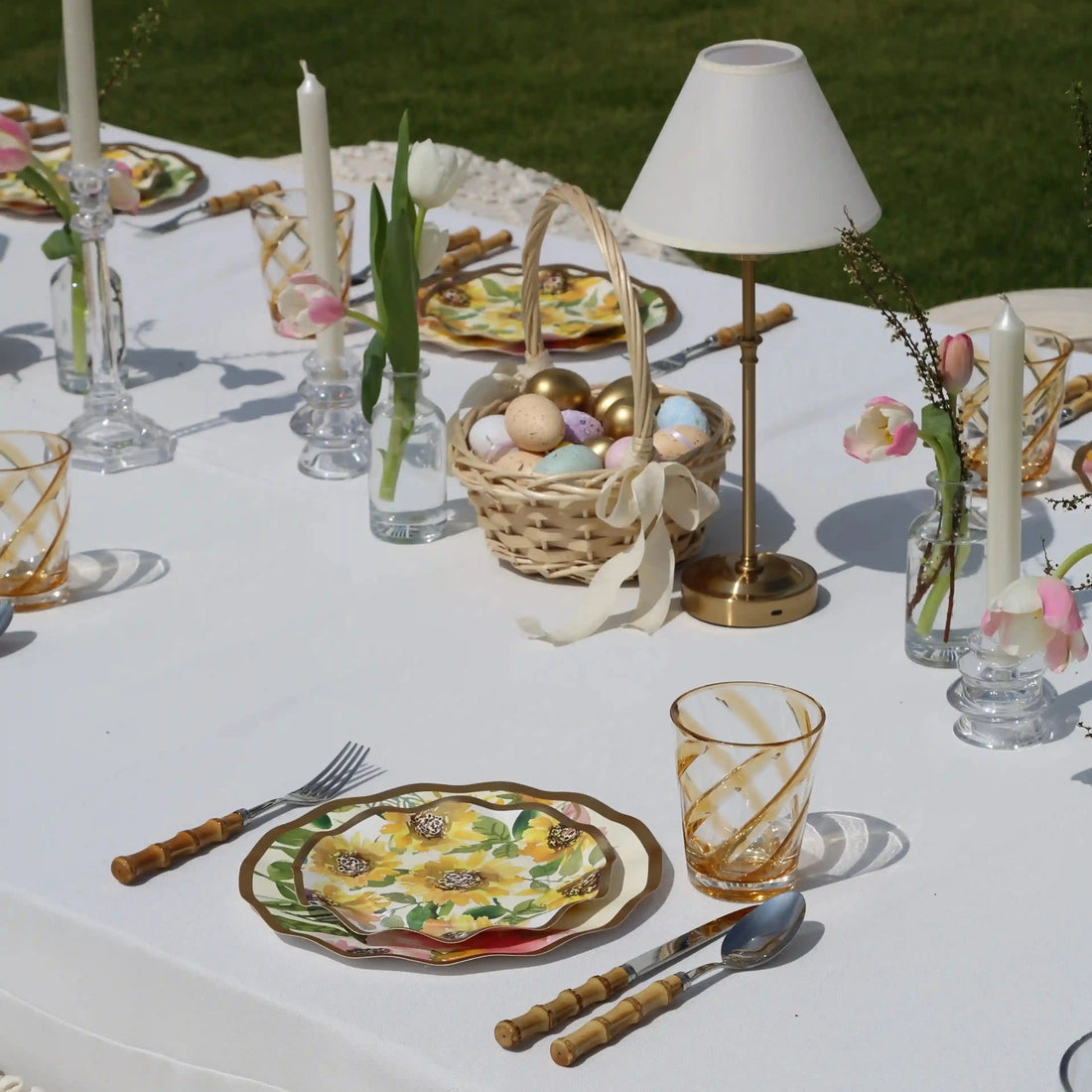 Amber Spiral Colored Acrylic Glass - Set of 4: Amber-swirled acrylic tumblers set on a spring-themed table with sunflower plates and pink-white tulip vases. Ideal for stylish outdoor dining.