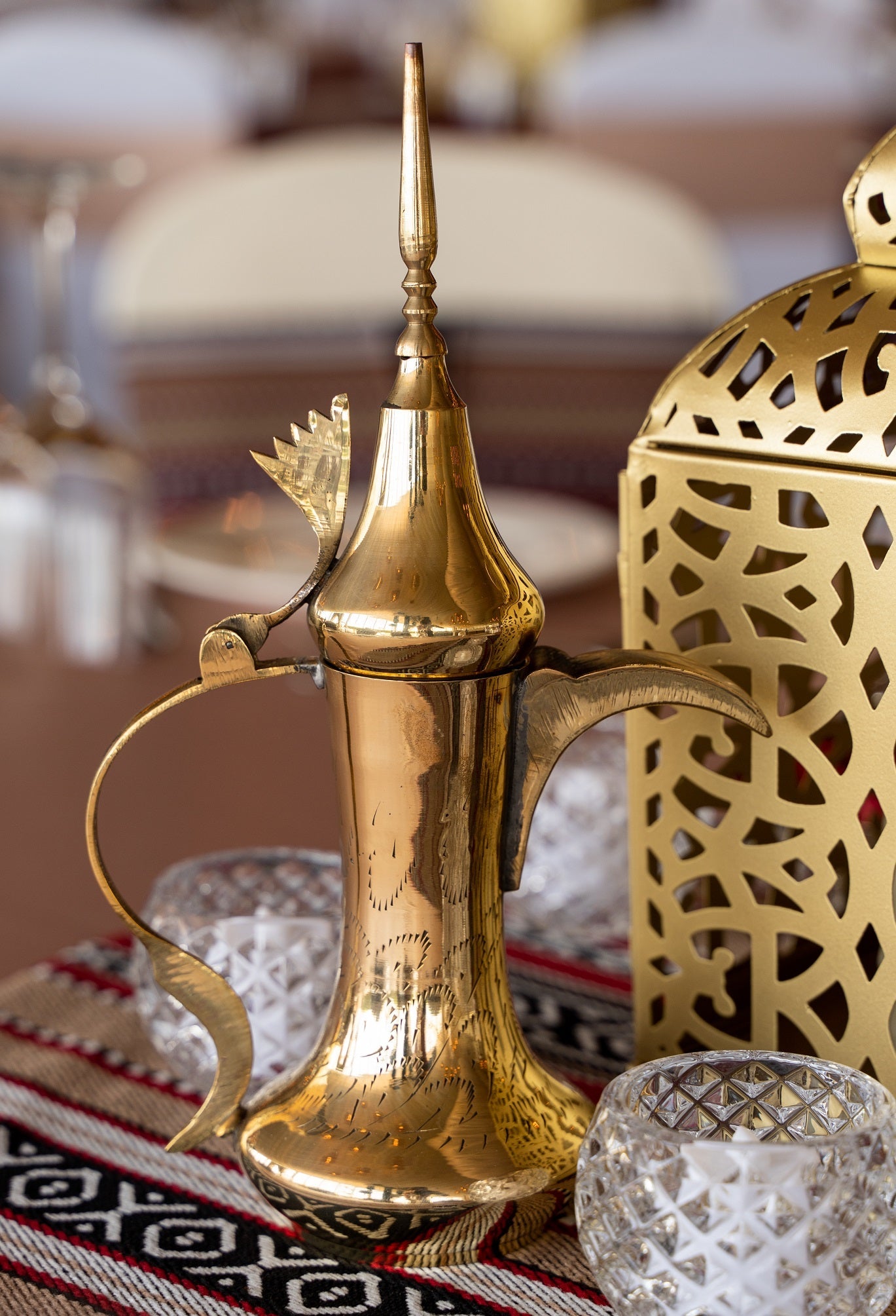 Dallah Arabic Coffee Pot with a gold metal body and glass container, ideal for serving traditional Gulf coffee or as a decorative piece.