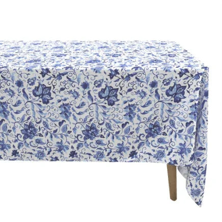Azure Garden Floral Tablecloth on a rectangular table, featuring a blue floral-and-vine motif, showcasing one visible wooden leg, ideal for elegant event settings.