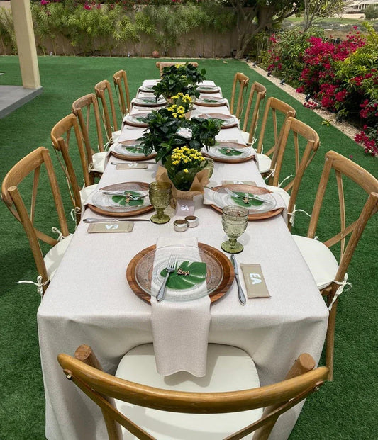 Table set for a dinner party featuring the TABLE 6' RECTANGULAR BANQUET, ideal for events, shown with elegant tableware and chairs.