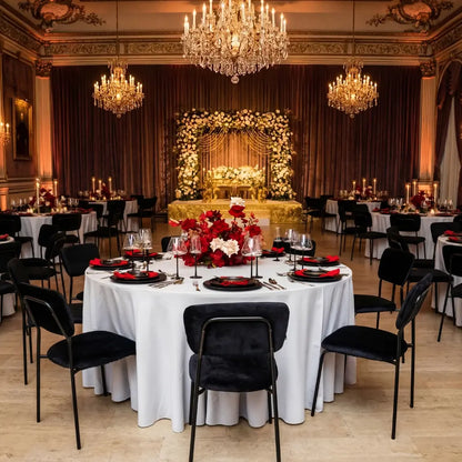 Simple Velvet Chairs with plush seating add modern glamour to a formal event setup, surrounded by elegant tables and luxurious decor in a banquet hall.