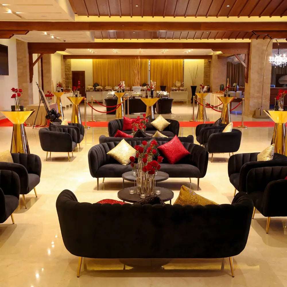 Black Velvet Single Seater: A plush armchair with slender gold legs, adorned with metallic accent pillows, perfect for elegant event lounging.