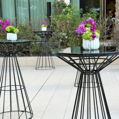 Black wire cocktail table with a black marble top, ideal for various events. Features a sturdy metal wire base and elegant fiber top.