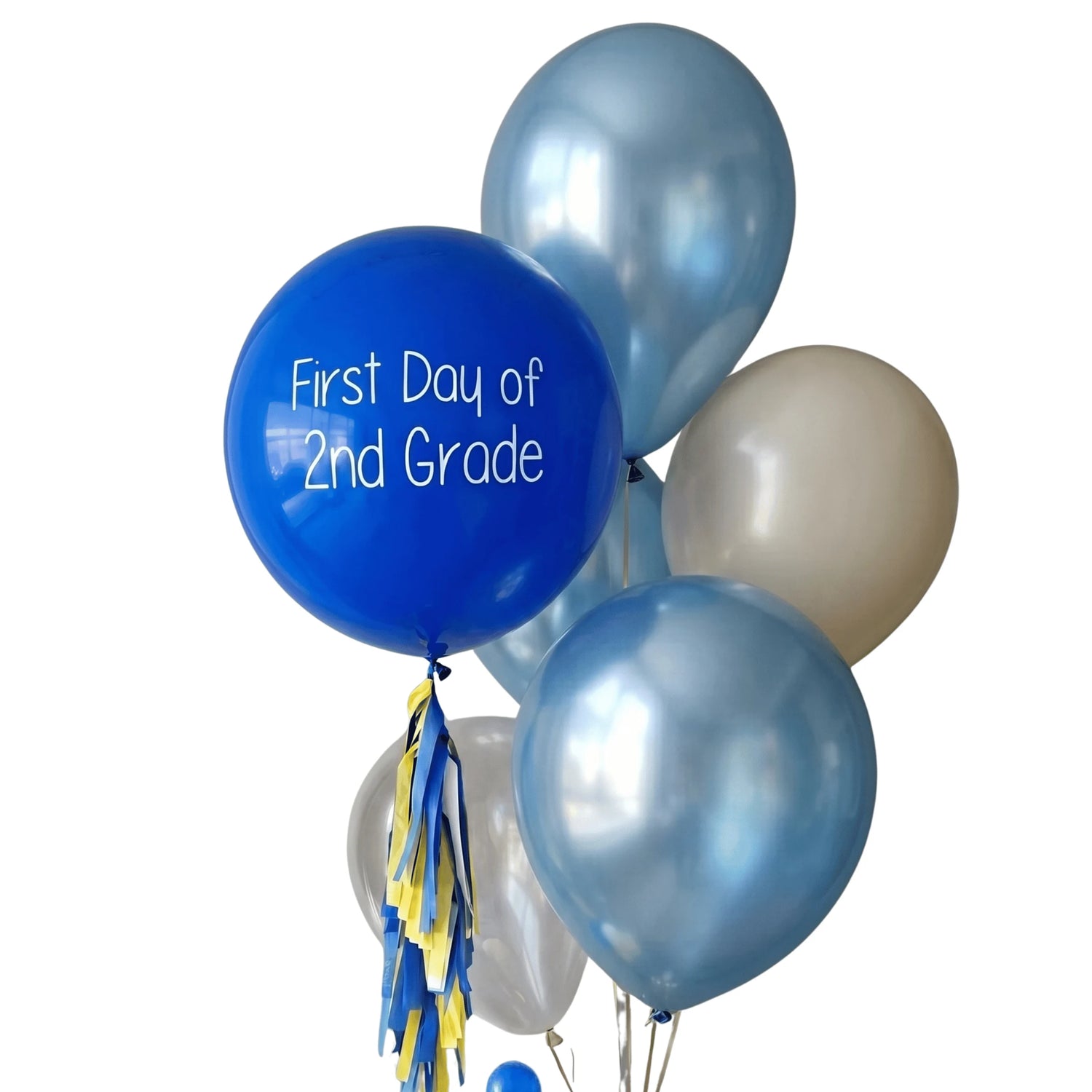 A cluster of metallic latex balloons in blue, silver, and cream, with one large royal blue balloon printed with the white text &