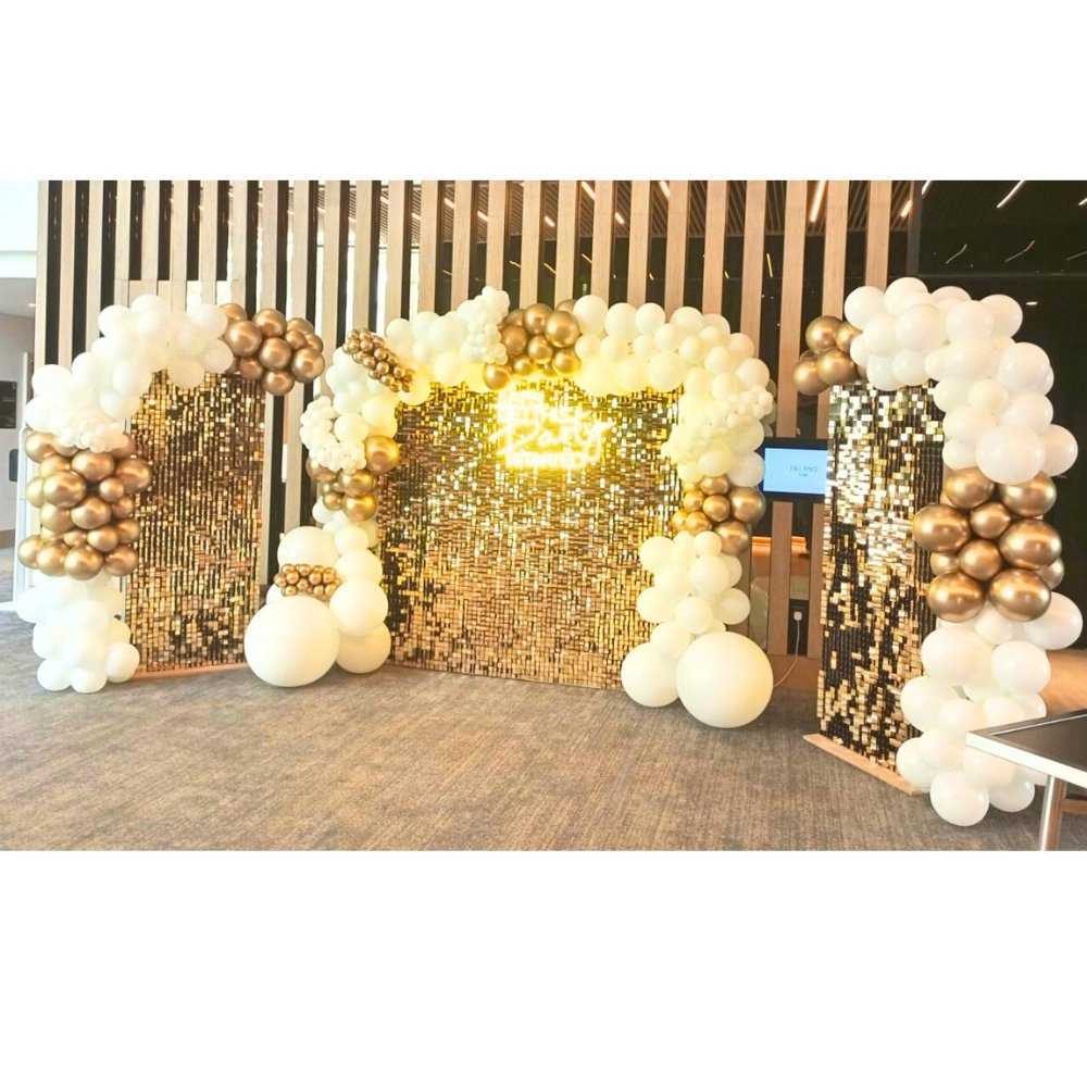 Golden Glam Wall Balloon Backdrop with gold sequin panels, white and gold balloons, and a neon sign, ideal for festive events like weddings or parties.