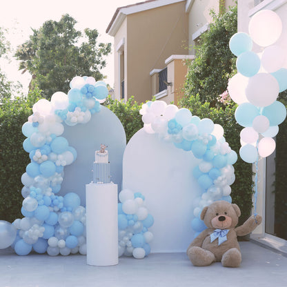 Large teddy bear with blue bow, surrounded by blue and white balloons, ideal for party backdrops and balloon decor from Party Social.