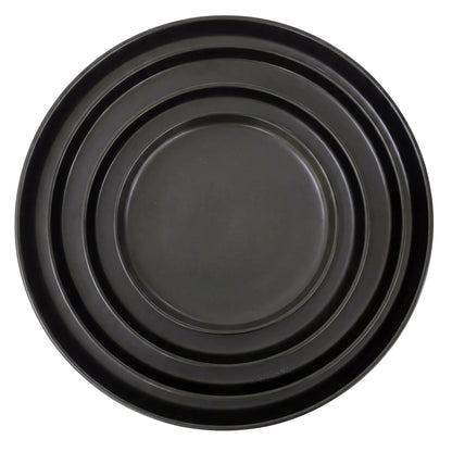 Black Ceramic Collection: A set of nested black metal baking trays in graduated sizes, perfect for enhancing elegant table settings at any event.